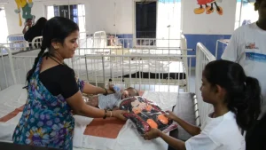 A kid ofering a school bag to a cancer patient