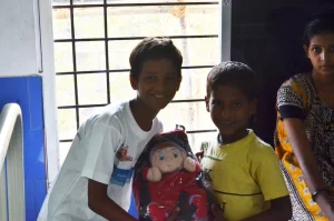 A young Hamara School kid with an inmate of the word, sharing a few toys in the bargain!
