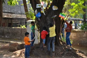 Displaying their work on a tree outside the Gonsalves Mansion