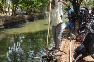Ghanashyam Chari helps with taking out the garbage from the creek