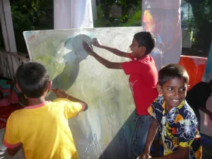 Kids seem very about painting the backdrop for Unnati Singh's painting