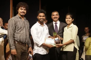 Rama Kankonkar & Olencio Simoes receiving their mementos from a student of Don Bosco College. John Desa, Convenor Transform Goa can also be seen.