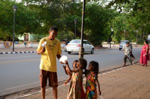  SLum kids running to get pamphlets