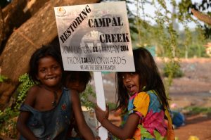 Slum kids hold placards to save the Campal Creek