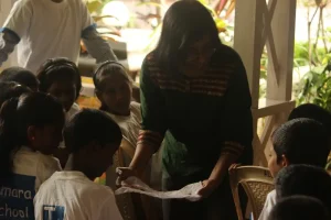 Volunteer showss around seeds to the audience