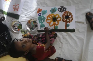 A kid painting flowers