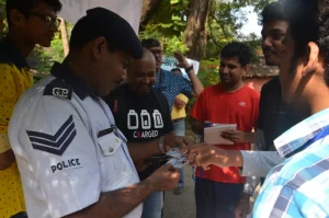 A Goa Police Traffic Cop checking the licenses of various participants!