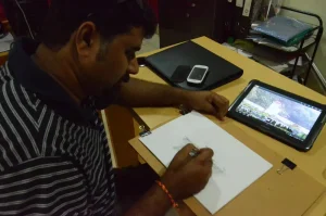 Artiste Vijay Bhandare seriously working on the sketch