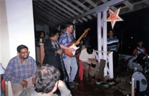 The audience enjoy the music while the chat with friends